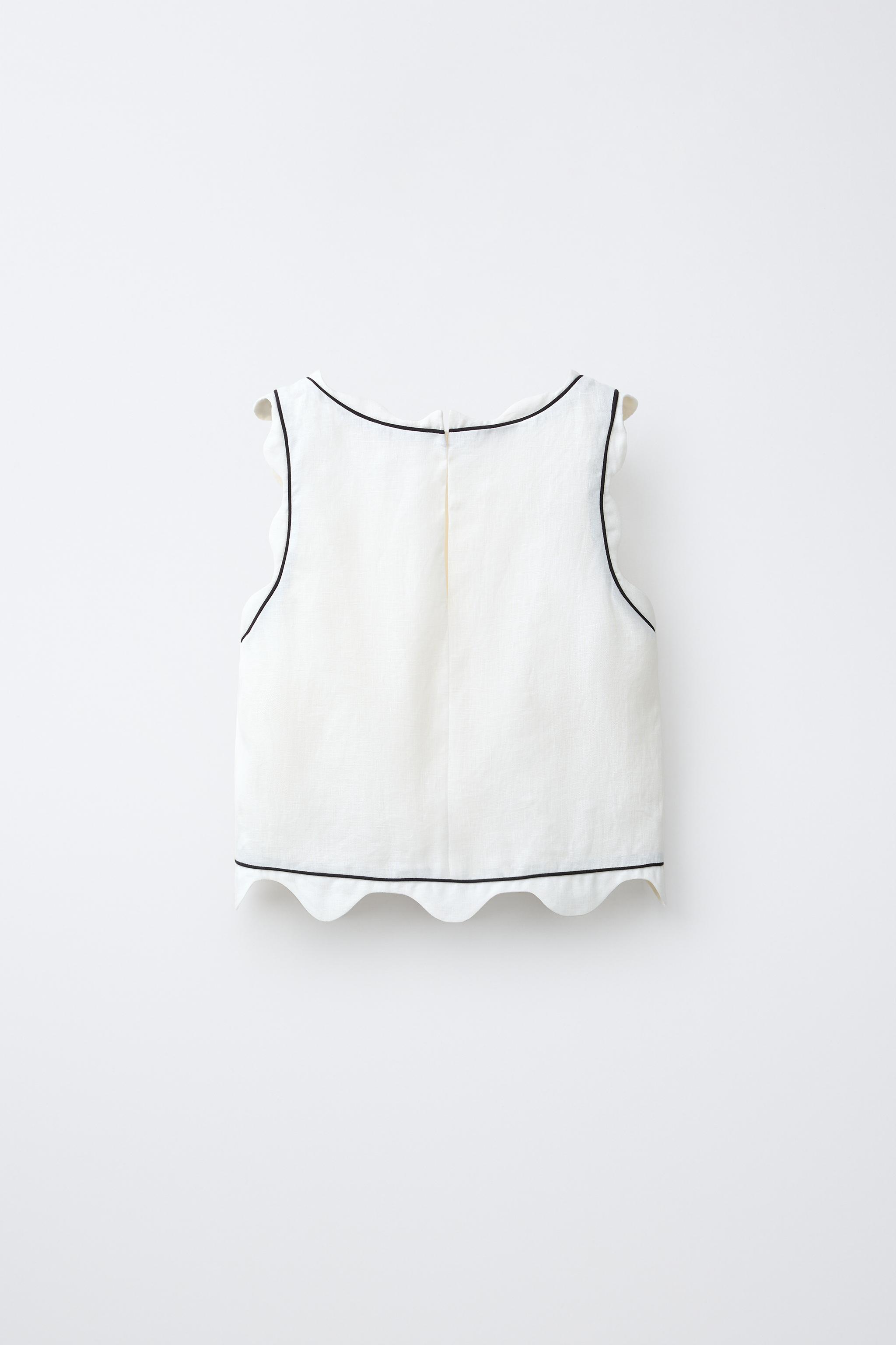 SCALLOPED TOP WITH CONTRAST PIPING